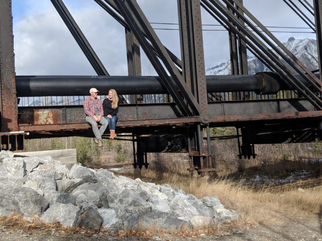 couple sitting on bridge